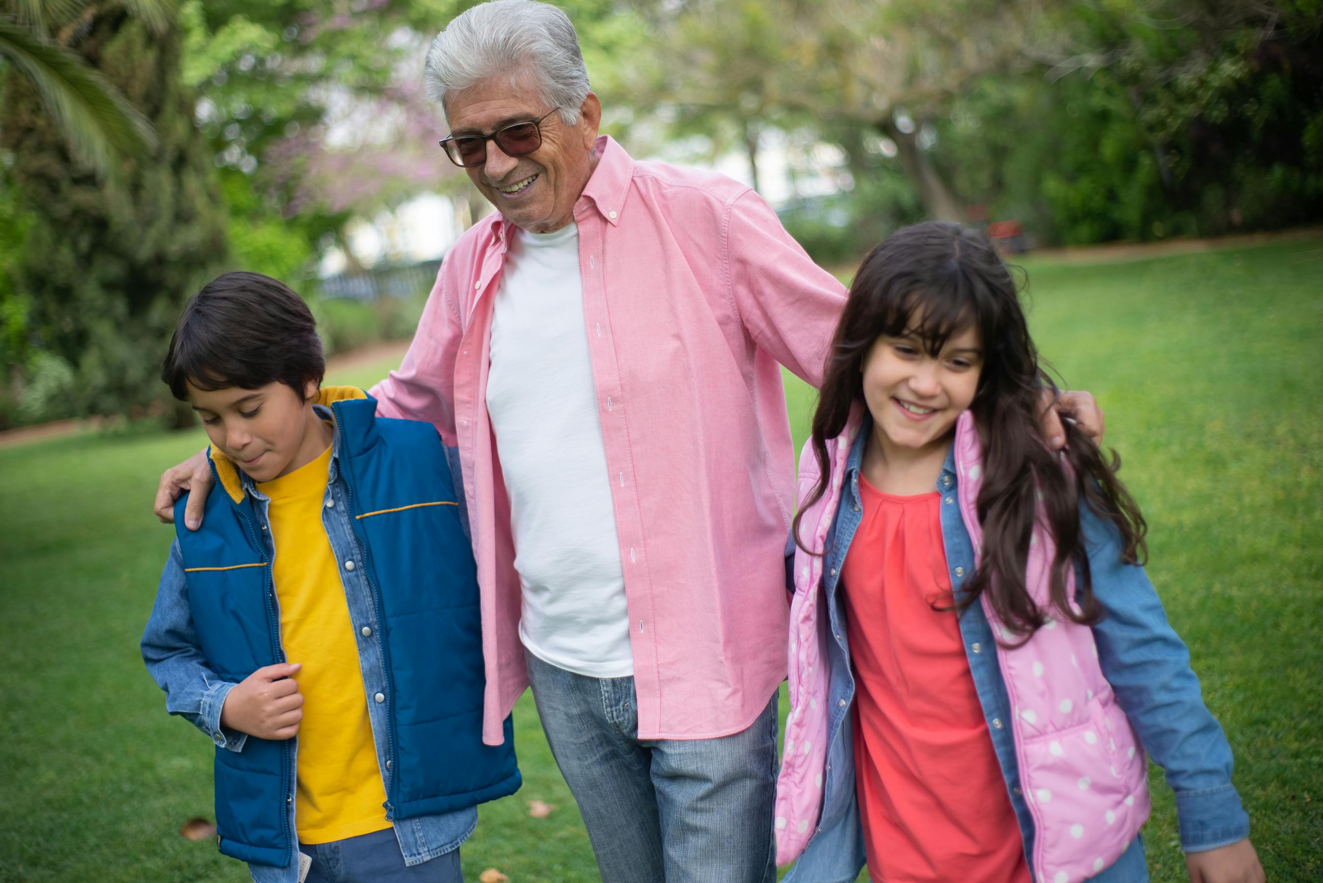 A grandfather with his grandchildren in a park